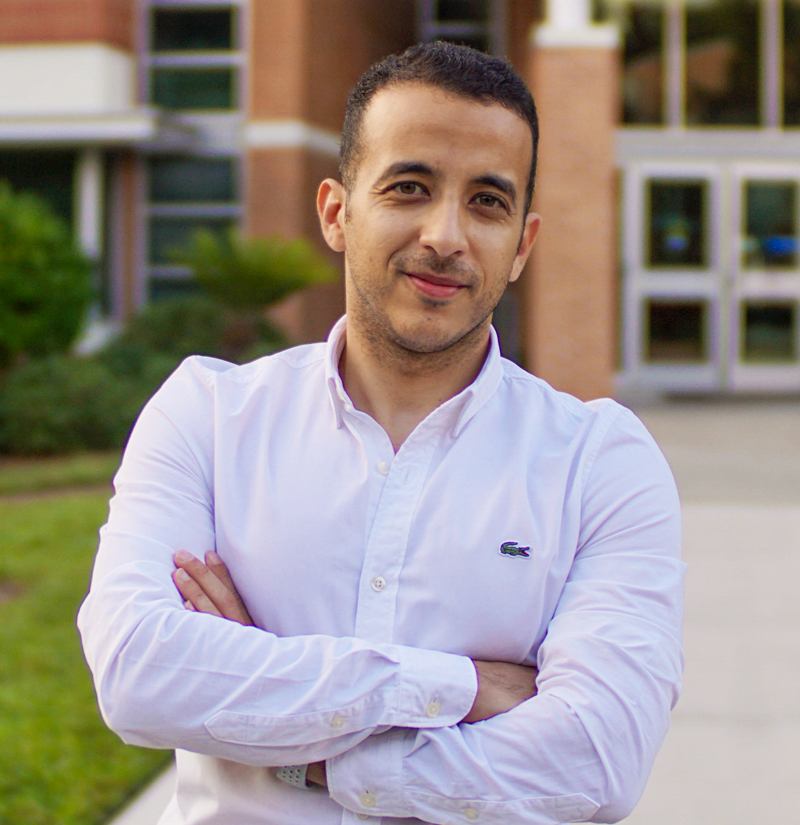 JU graduate student Ahmed Rashed standing in front of the Davis College of Business & Technology building.