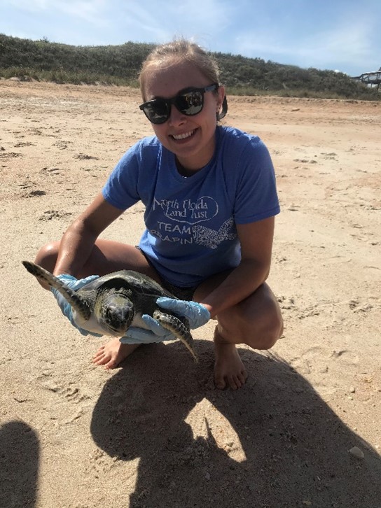 girl smiling with turtle