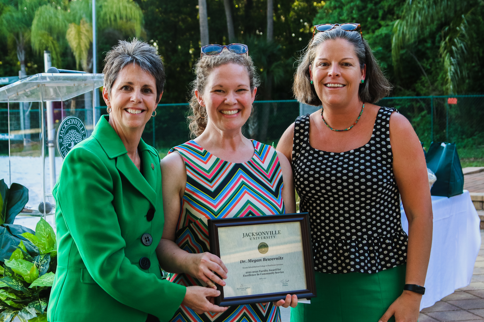 Dr. Bewernitz (middle) is recognized with the Faculty Excellence Award for Community Service. Photo by Taylor Sloan.