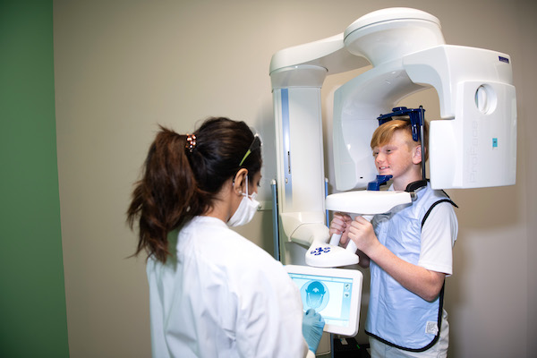 A an orthodontics student taking panoramic x-rays on a patient.