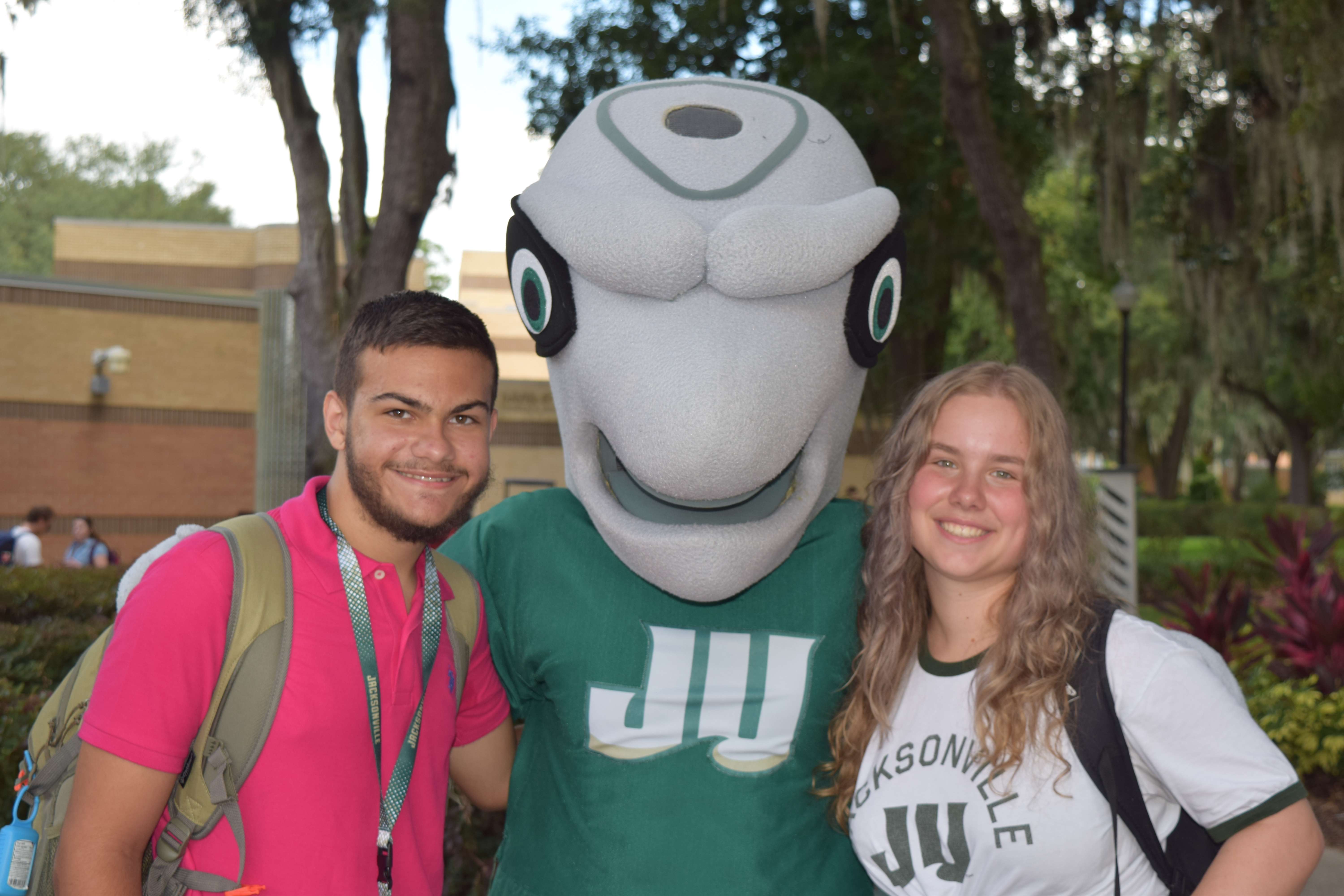Students smiling with mascot, Dunkin