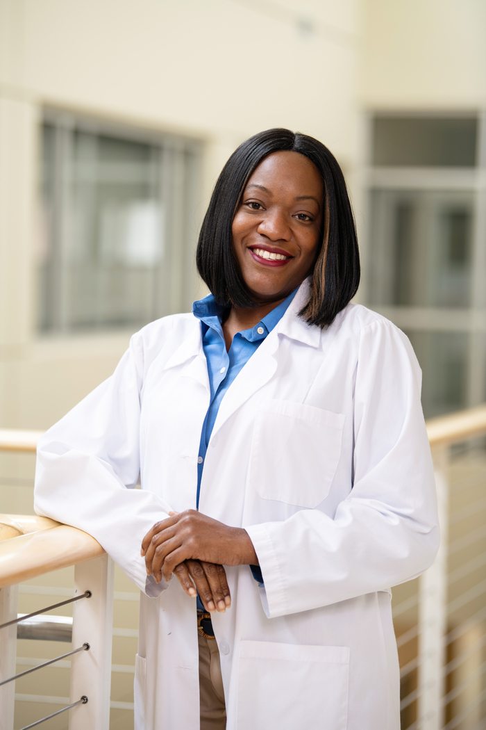 A female medical professional posing for a photo.