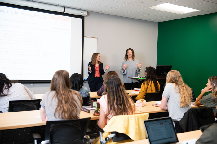 Two female teachers instructing a class