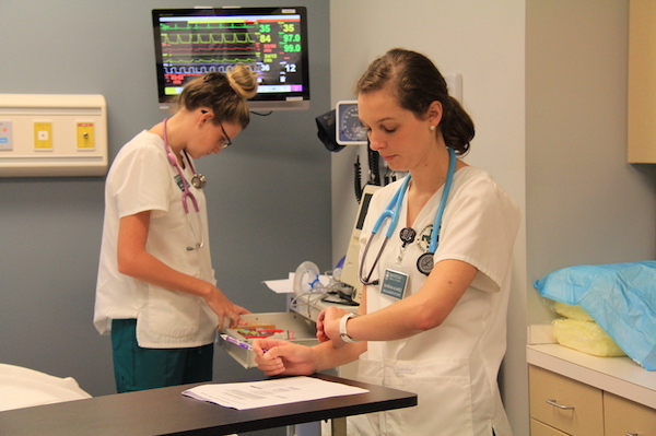 Two students practicing in the simulation center.
