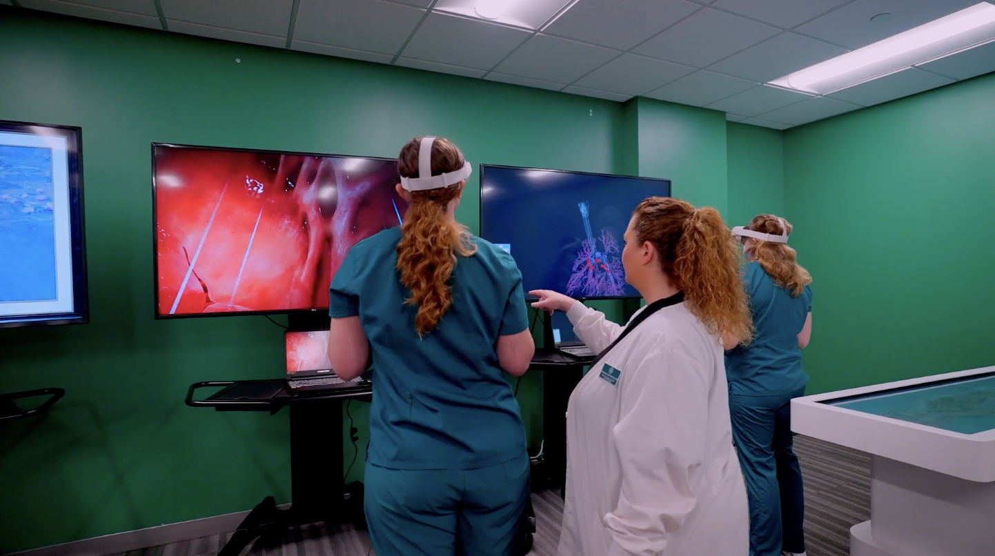 Nursing student using VR simulation with nursing instructor