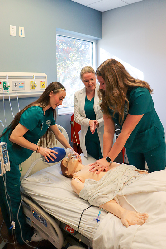 Nursing students perform CPR to a medical maniken