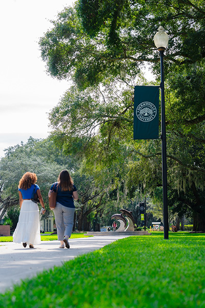 Two students walking on campus