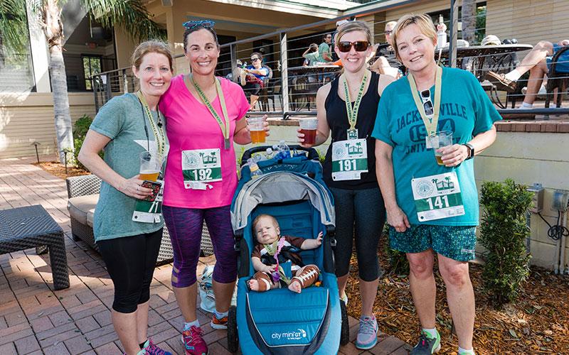 A group of runners celebrating at the River House