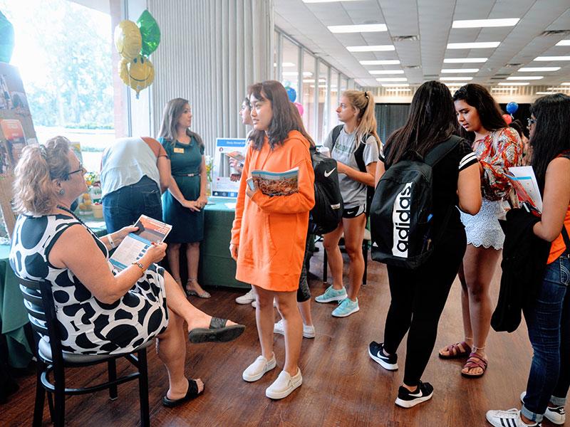 A student speaks with a faculty member about study abroad.