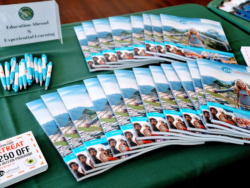 Some study abroad pamphlets on a table.