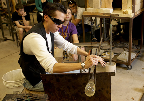 Students working with glass in the workshop.