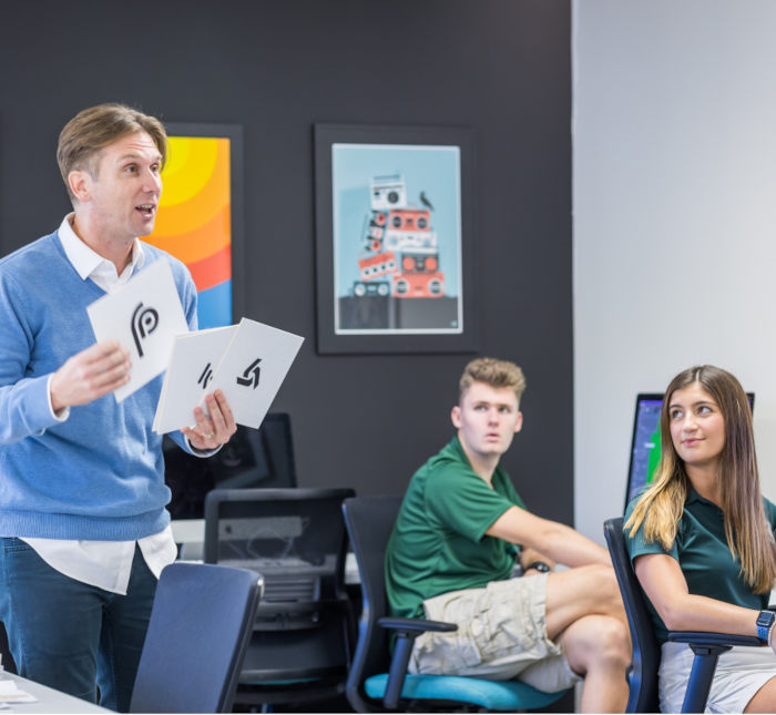 students in classroom looking at professor teaching. 