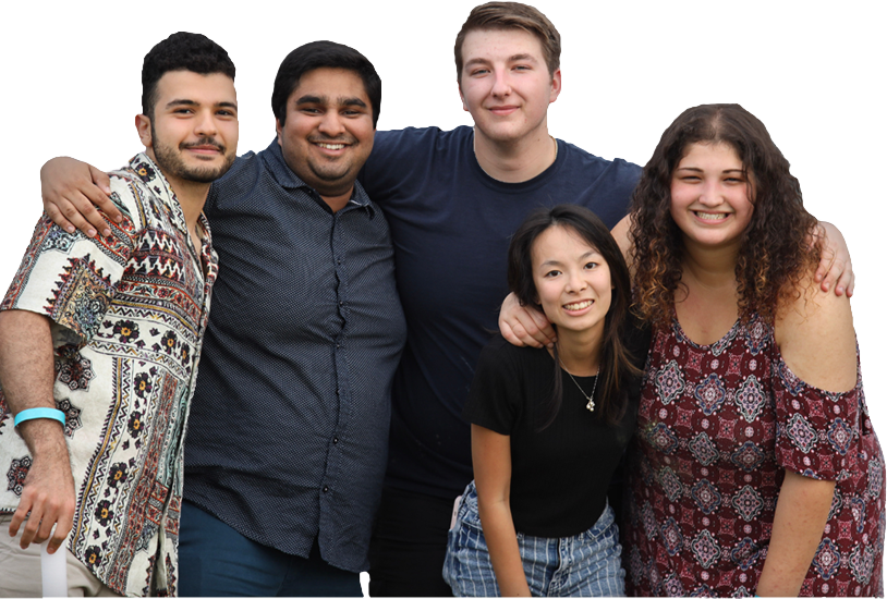 A group of five students pose for a group photo with their arms around one another's shoulders.