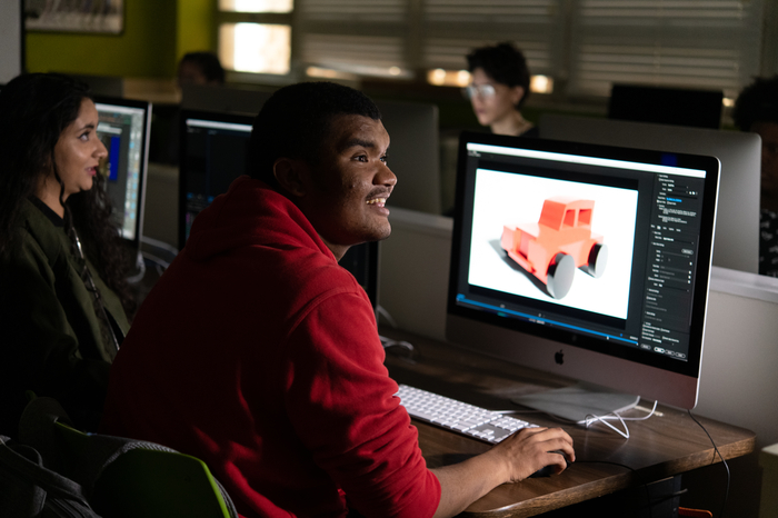 A graphic design student working at his computer.