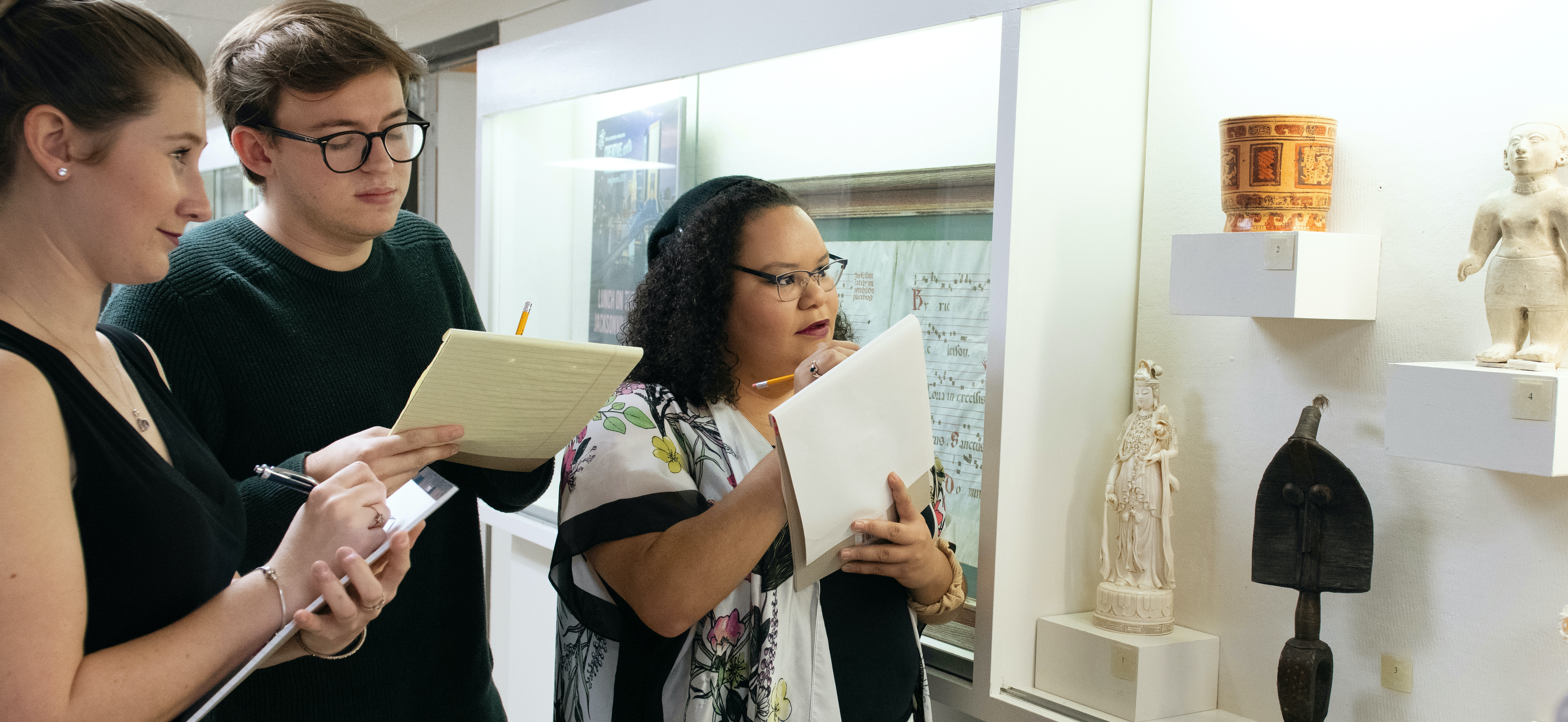 Art history students examining non-western objects from the University’s permanent collection.