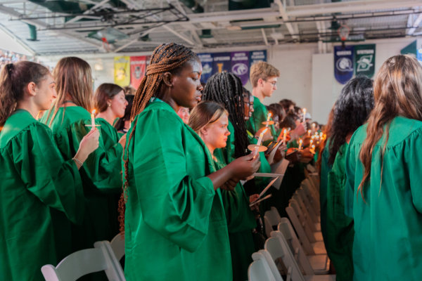 students holding candles at matriculation