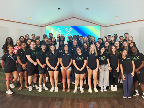 Students wearing a Campus Recreation and Wellness attire in the gym's office.