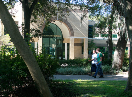 Two students walking in front of Davis Student Commons