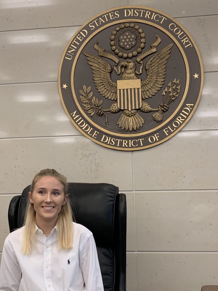 A pre-law student poses for a photo at the U.S. District Court for the Middle District of Florida.