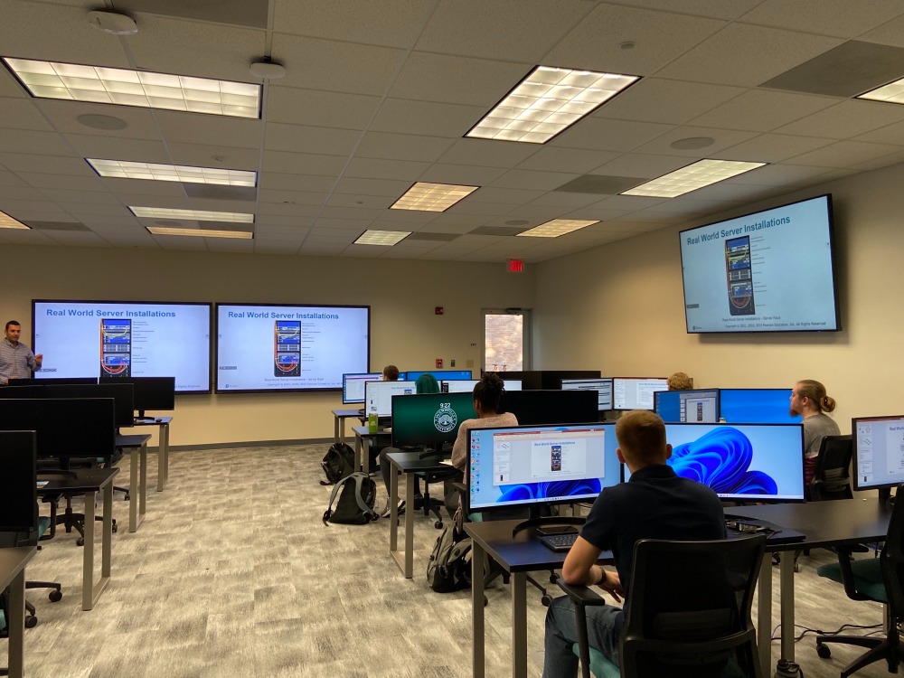 A Computing Science professor teach students in the computer lab.