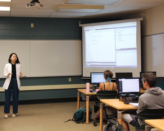 A Computing Science professor teach students in the computer lab.