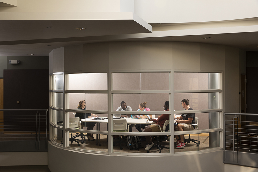 Students meeting in an upstairs room in the Davis College of Business building.