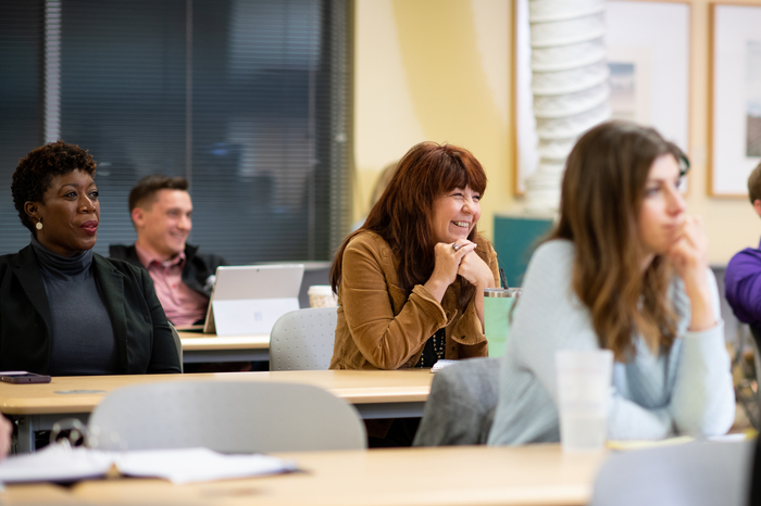 Smiling JU students engaged in learning in the classroom.