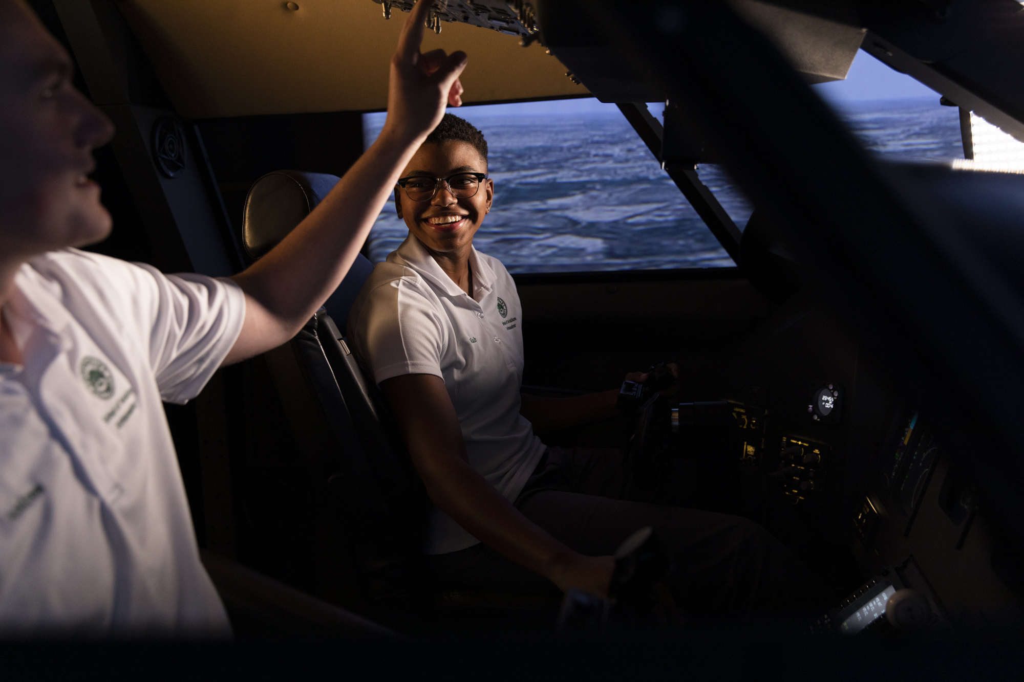 Two students in flight simulator.