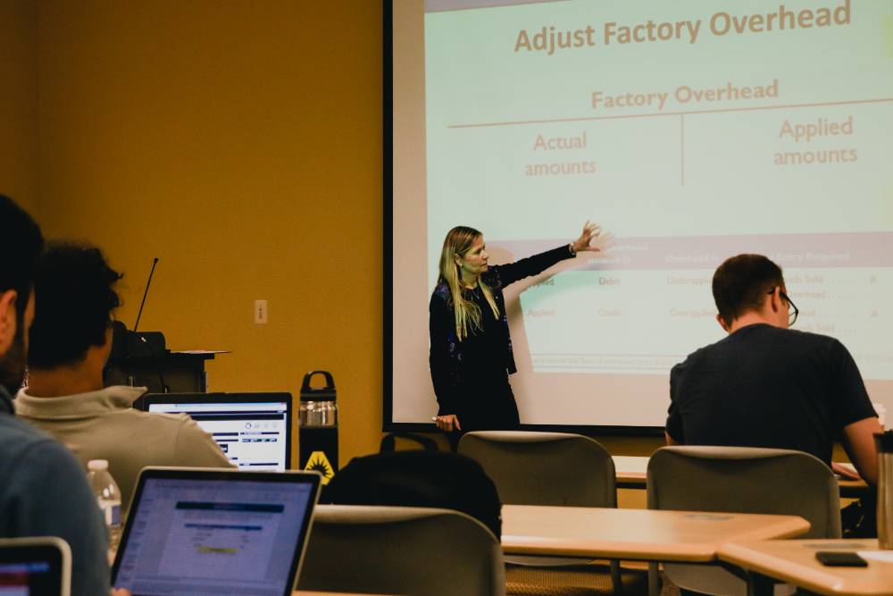 JU professor teaching using a projector.