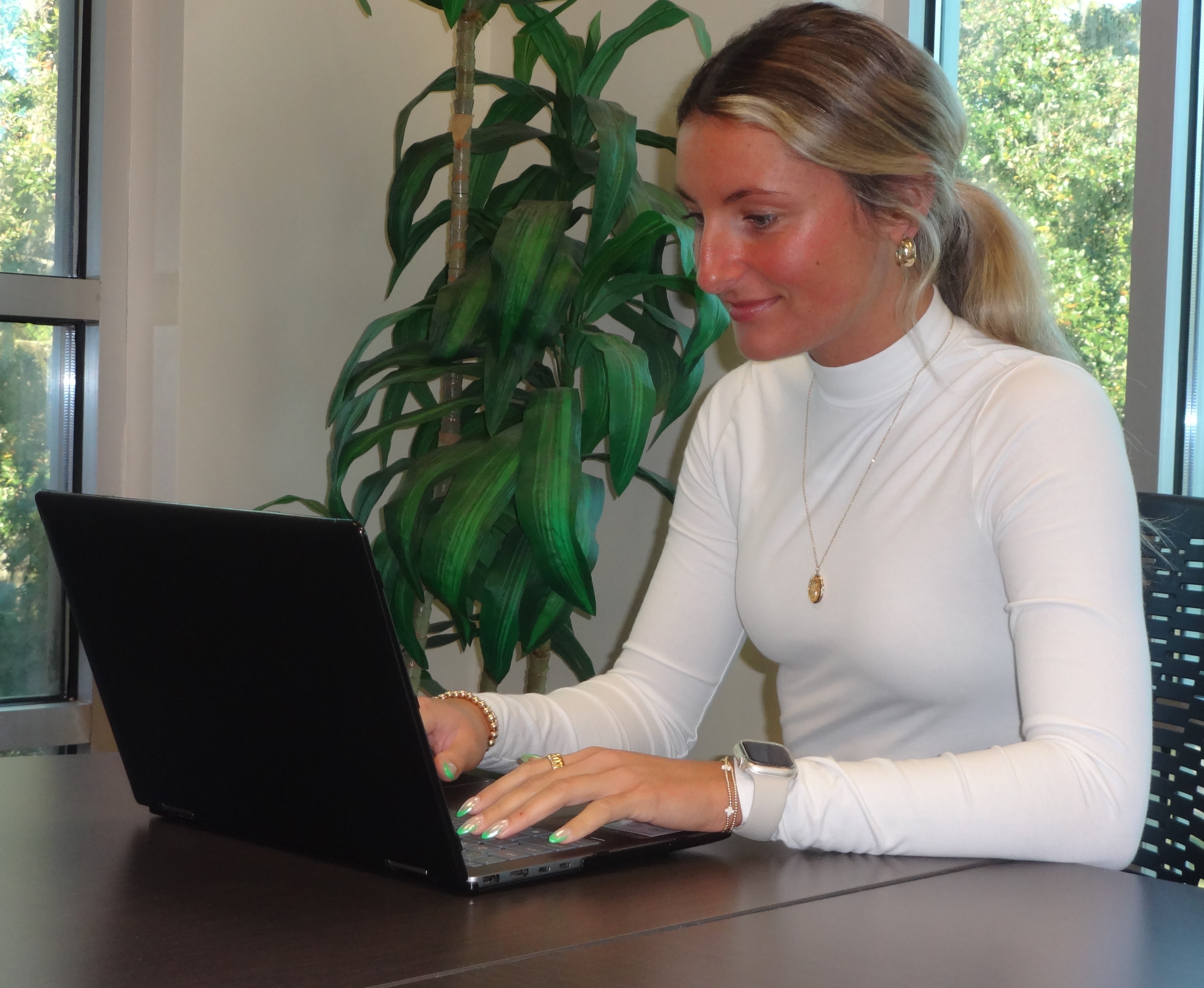 A close-up picture of young woman on laptop