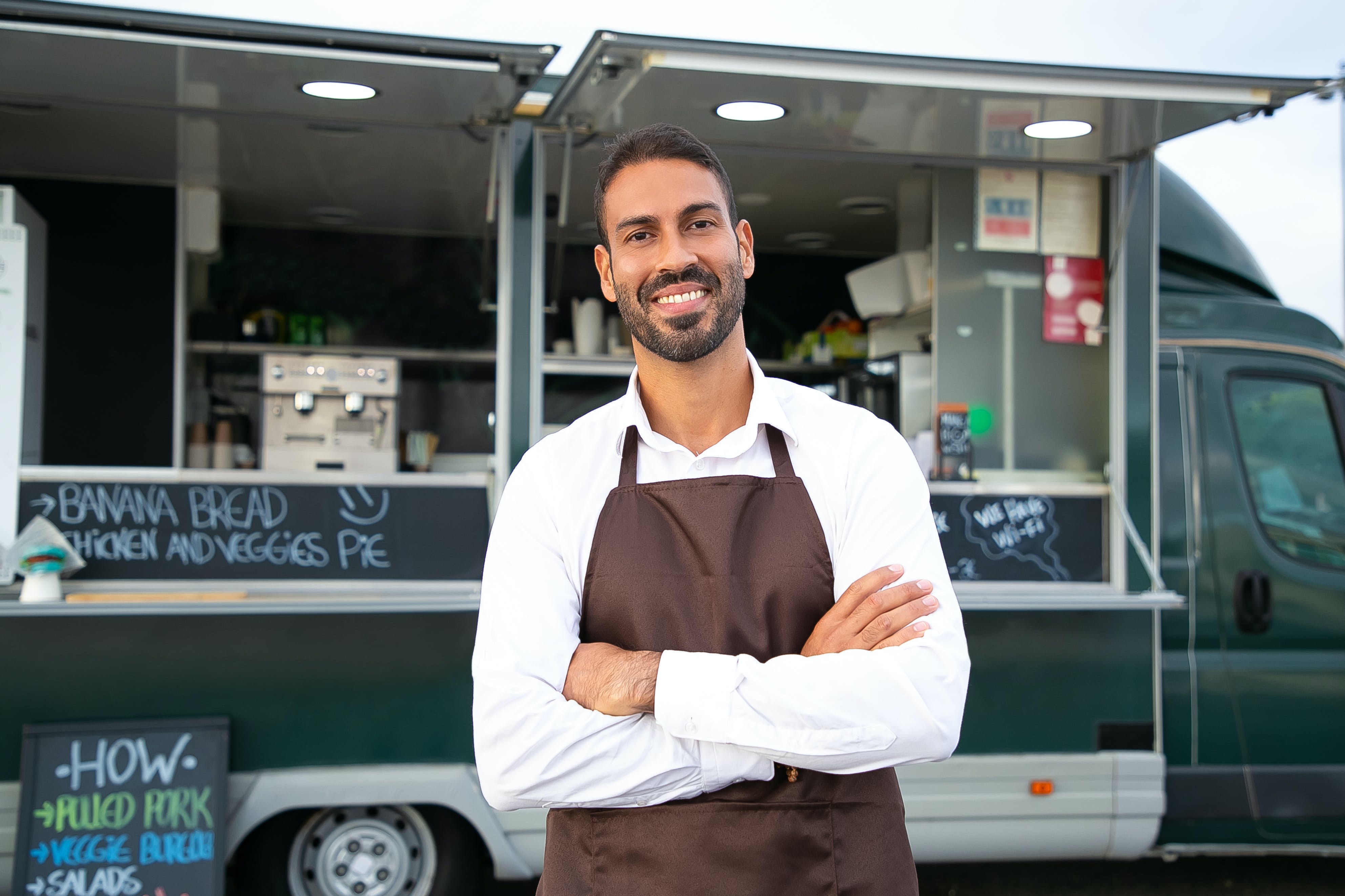 Business owner in front of food truck