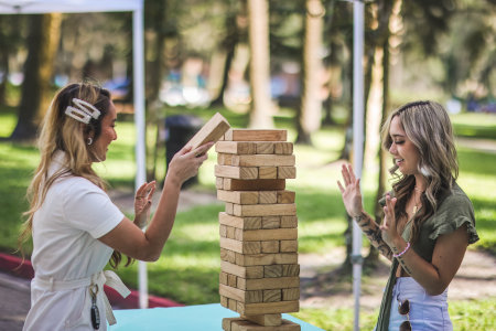 Female students building blocks together.