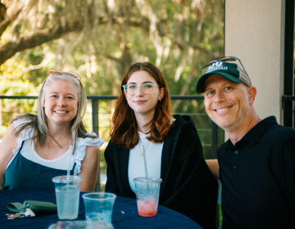 Parents and Student seating at a table with cool beverages.