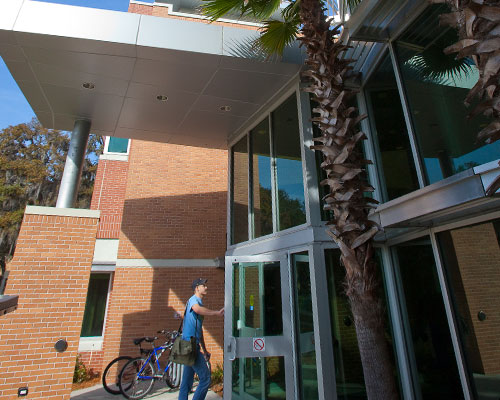 A student walking into Davis College of Business & Technology