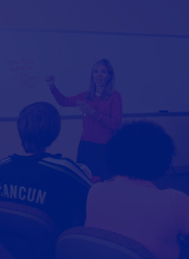 A teacher and students in a classroom.