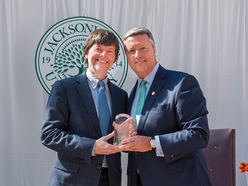 2016 honoree Ken Burns holding his award with President Tim Cost.