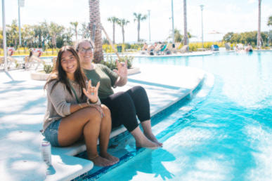 students seating by the JU pool