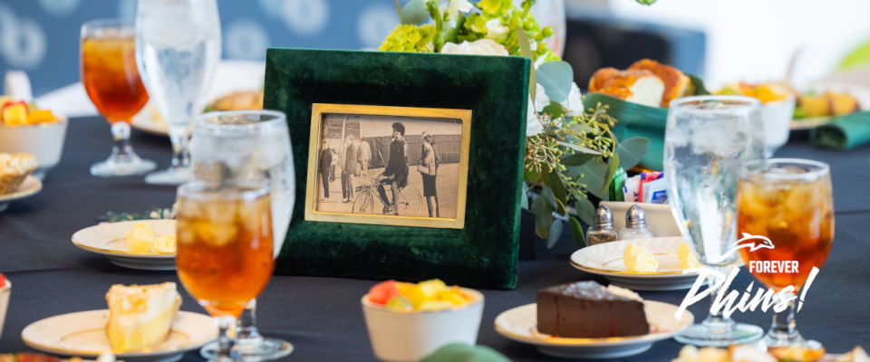 A black and white framed portrait placed on a banquet table.