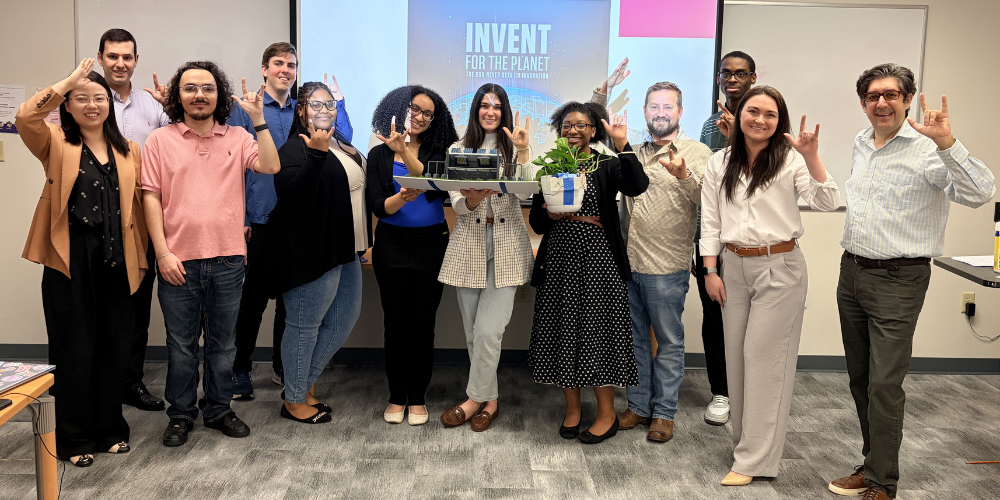 JU computer science students stand with their prototype for the IFTP Hackathon.