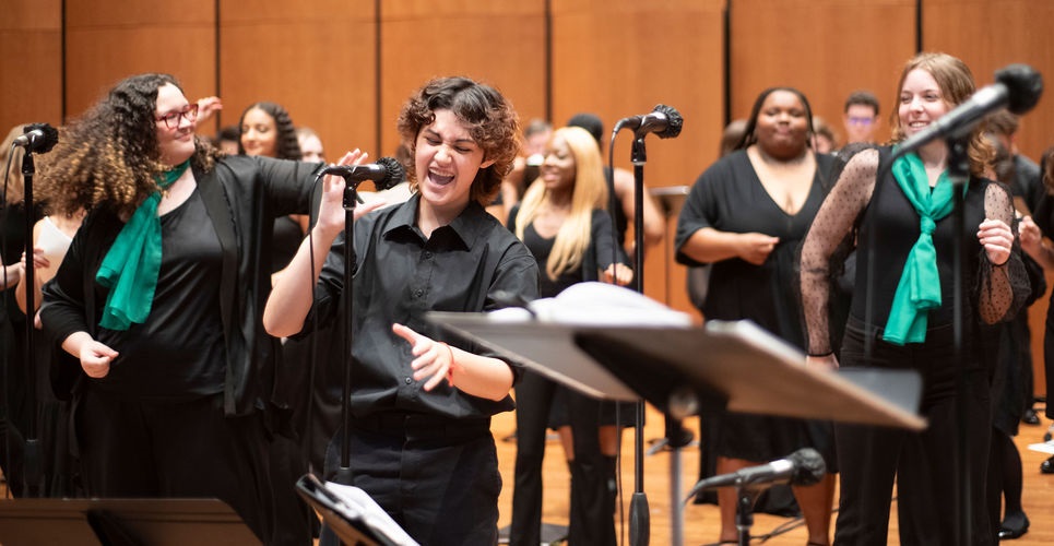 Naib (Nickolas) Kepe singing an exciting, solo high note in Time Warp with the combined choirs of Jacksonville University.