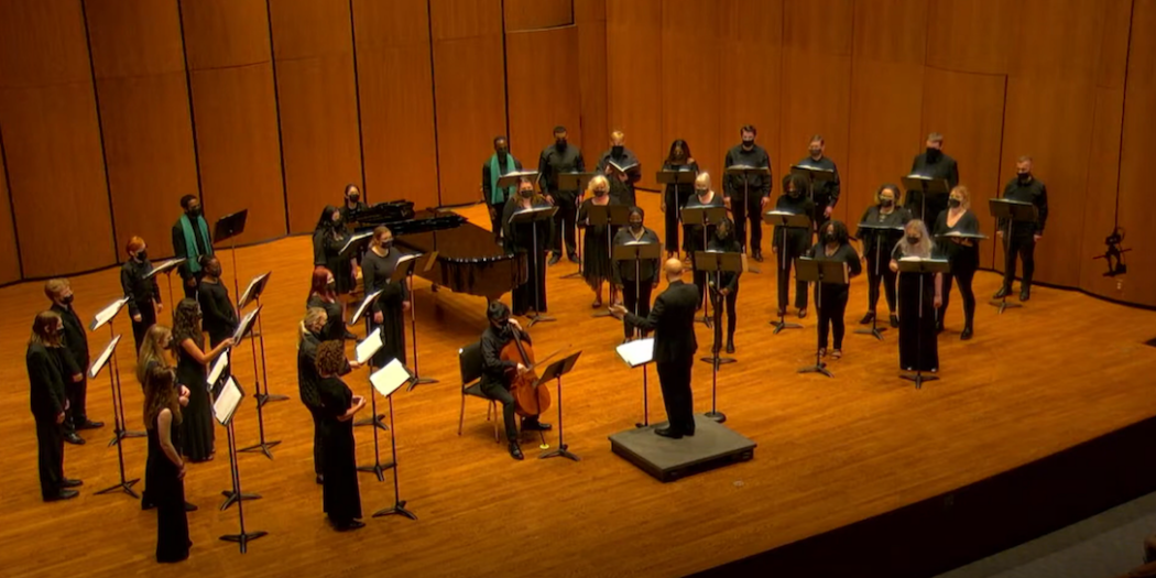 Group of choral singers performing with Choral Director Dr. Julian Bryson.