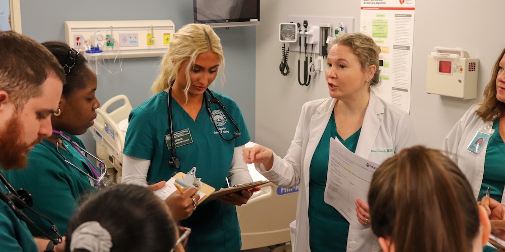Nursing students listening to faculty member