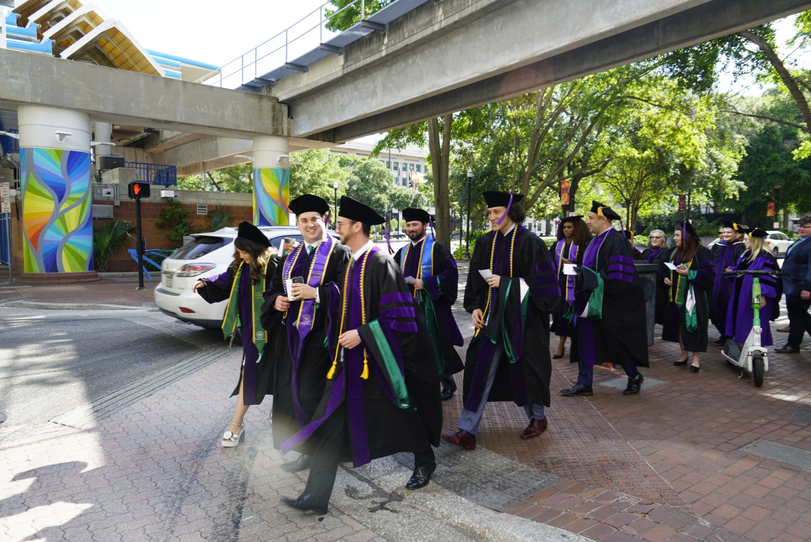 Inaugural class walking in caps and robes Downtown