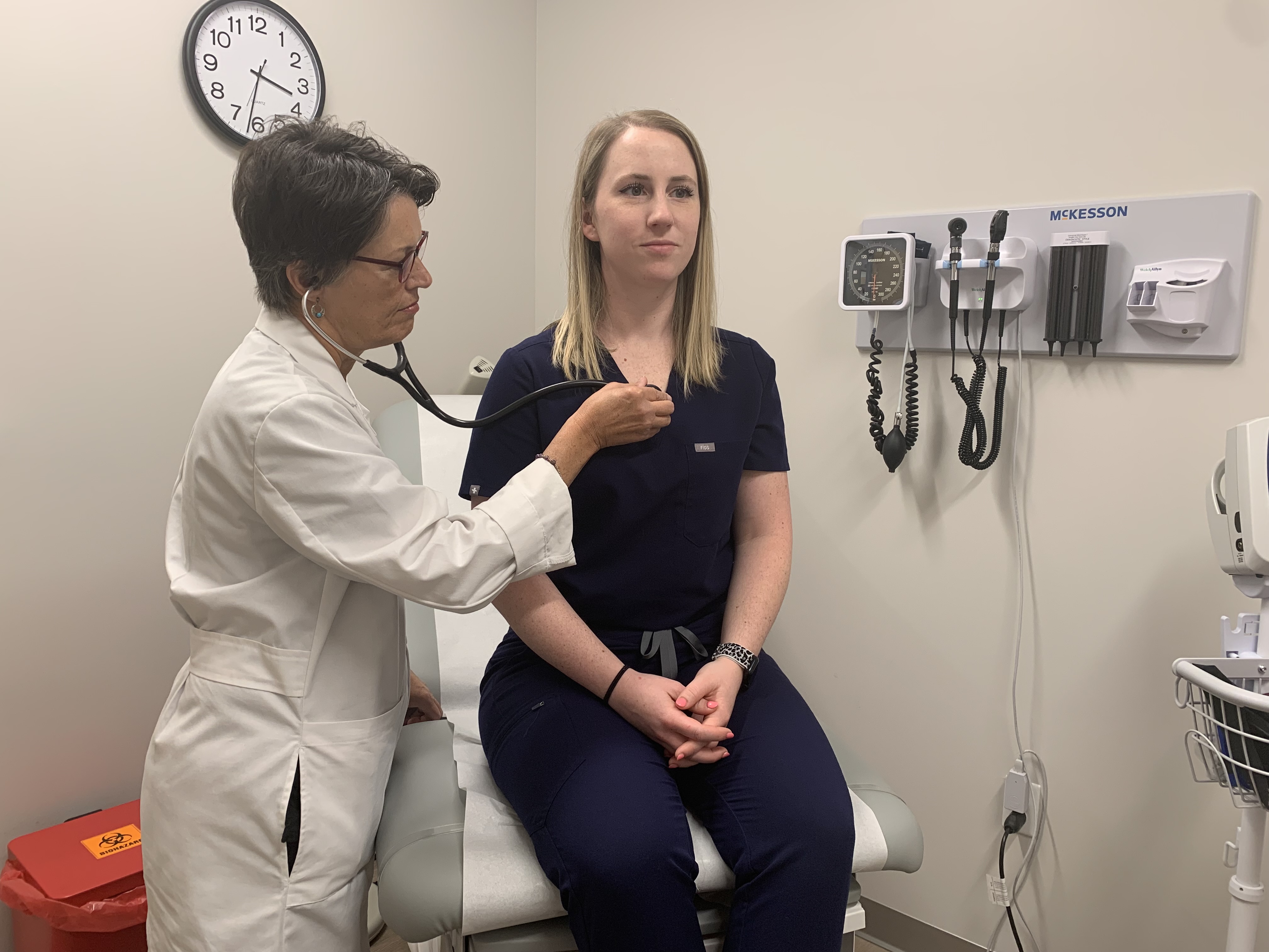 Nurse giving check-up in student health center
