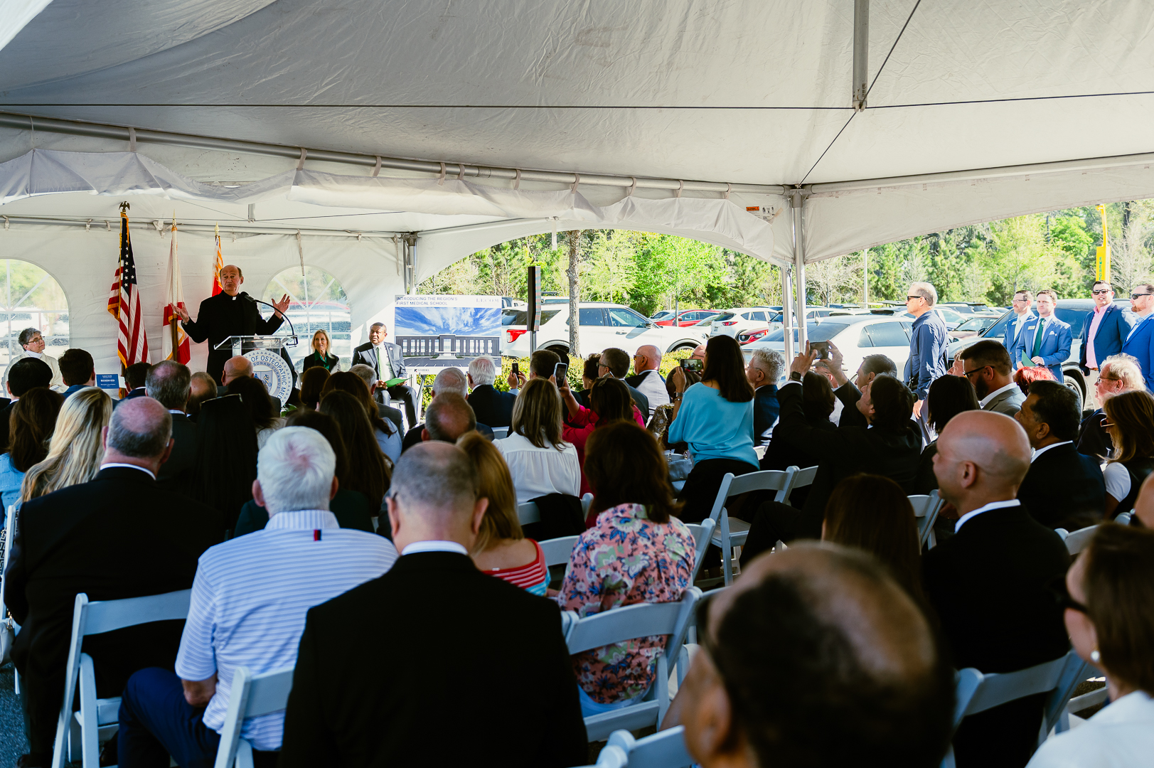Visitors under tent at groudbreaking