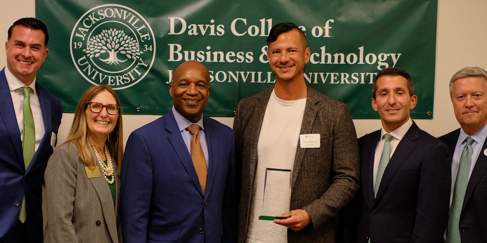 Matthew Chang holding award