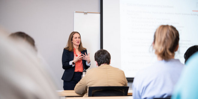 A female teacher instructing multiple students in health sciences