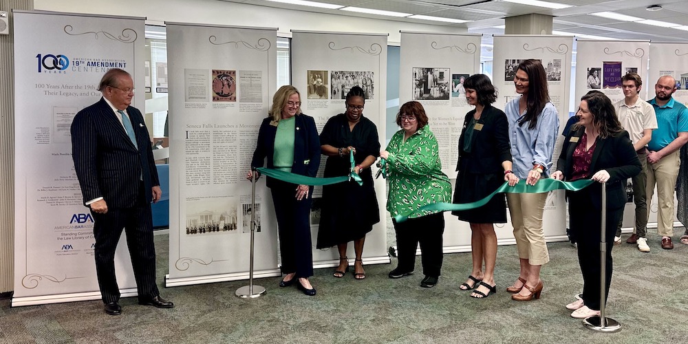 the ribbon is cut for the 19th amendment exhibit in the Swisher Library
