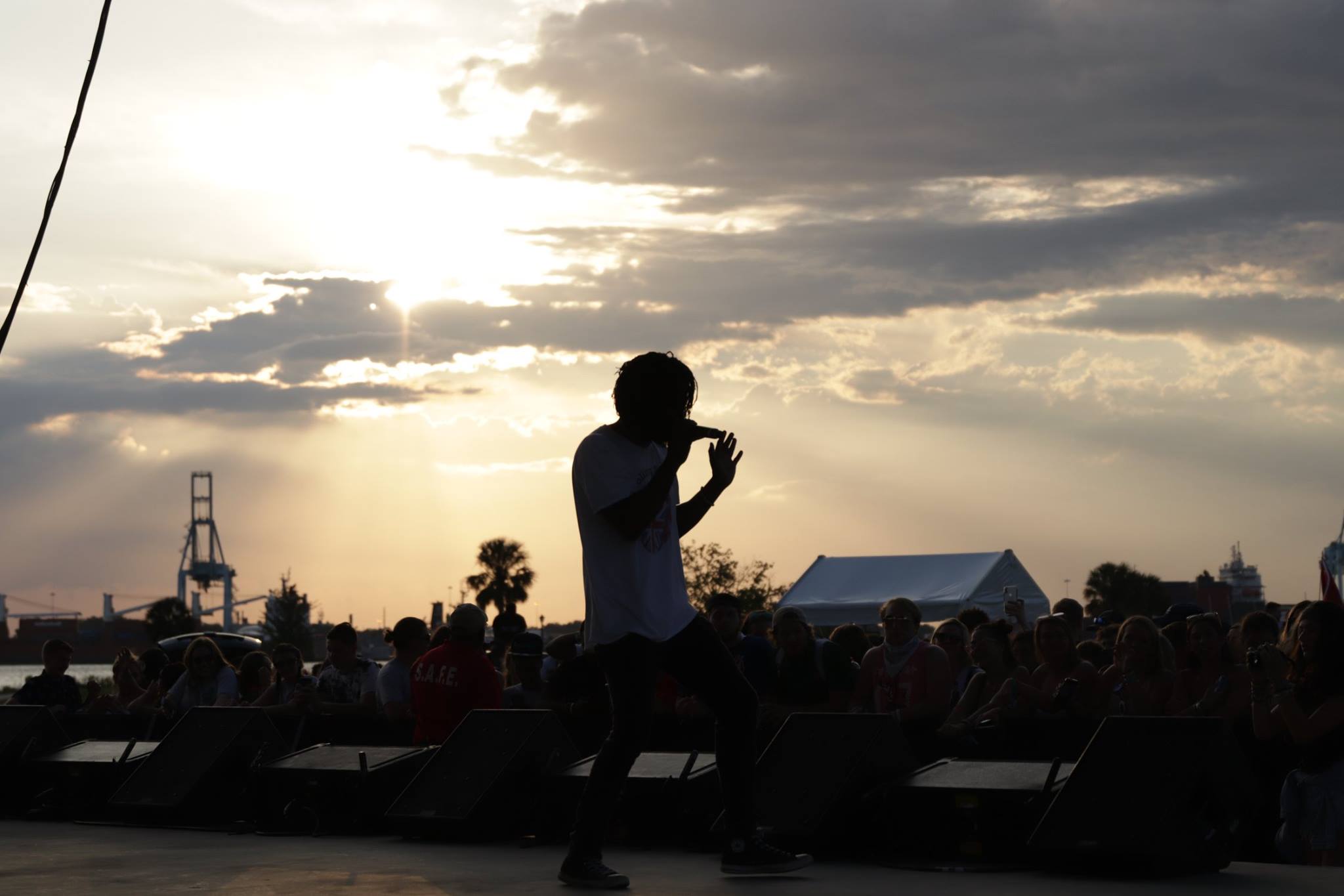 silhouette of a performer singing onstage at Porter Fest in 2019