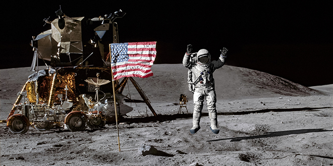 astronaut plants american flag on the moon